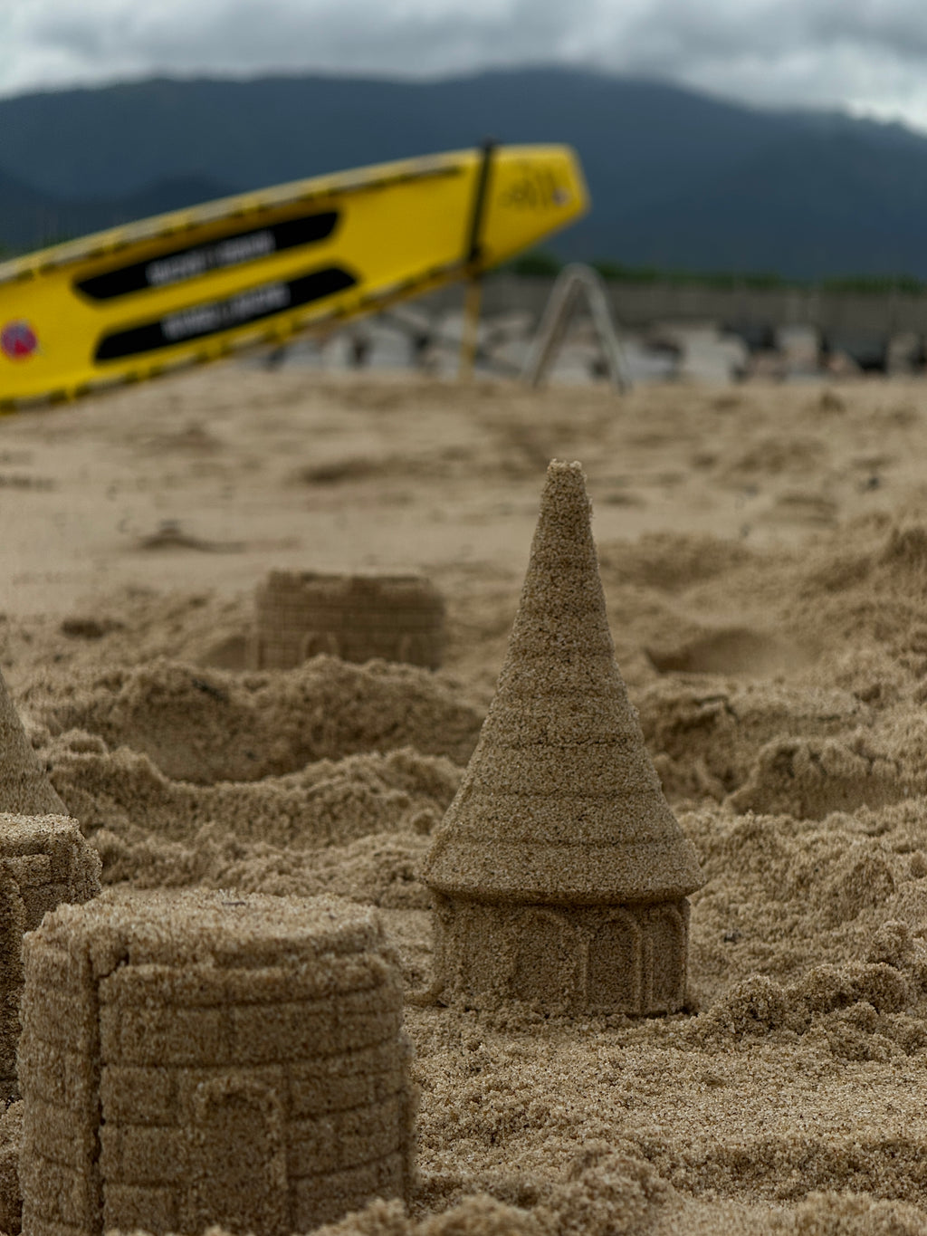 Family using Pipin.World easy-release sandcastle mold, perfect beach accessory for vacations